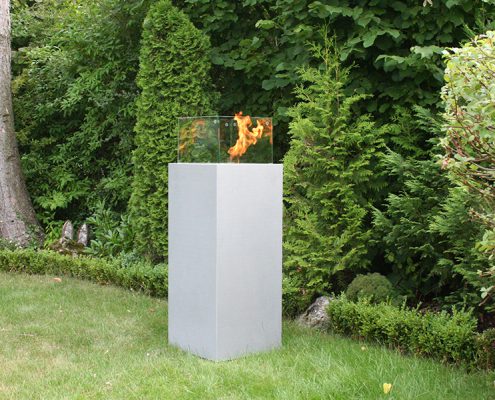 Feuersäule aus Beton mit Windschutz im Garten